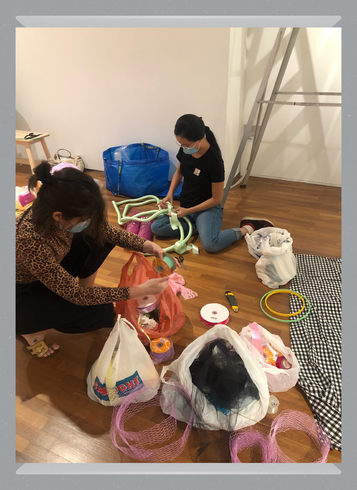 Stephanie and her assistant Dwi sorting through materials while constructing the artwork in the gallery.