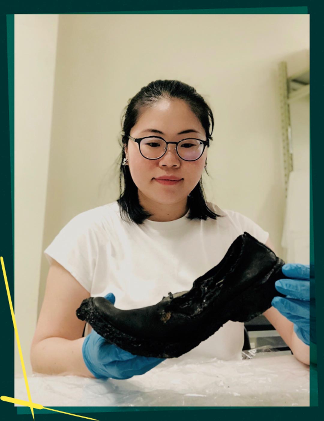 Joanne holding one of the footwear from Burned Victims